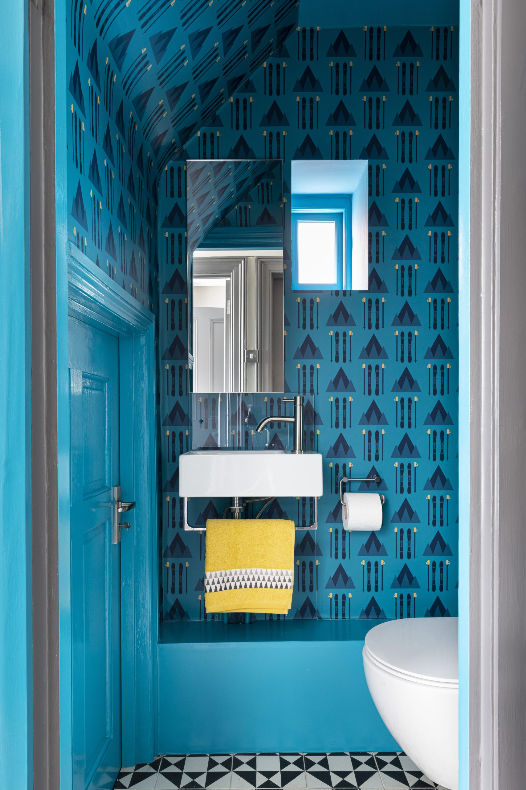 Ski-style wallpaper in bespoke cloakroom