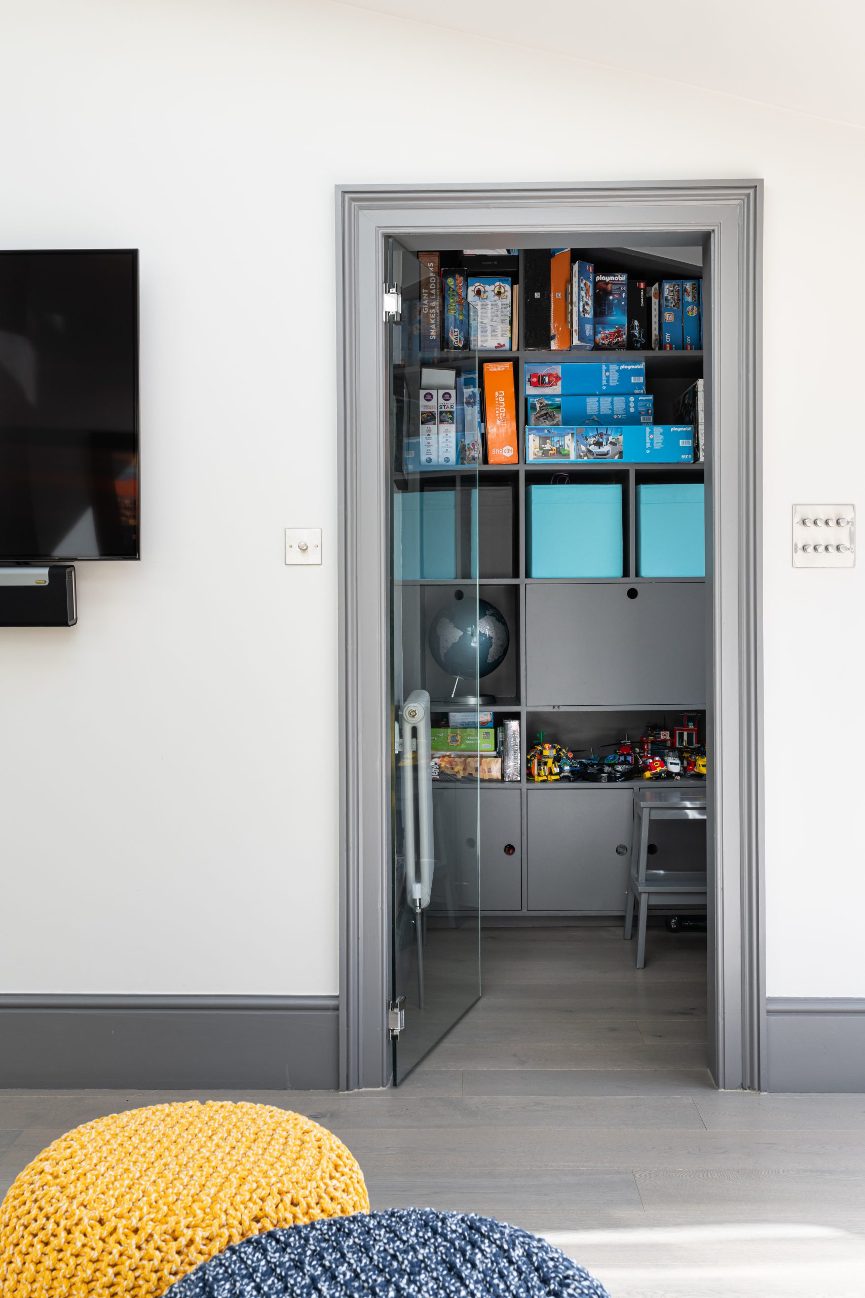 Boy's toy storage area in home design by Emma Green