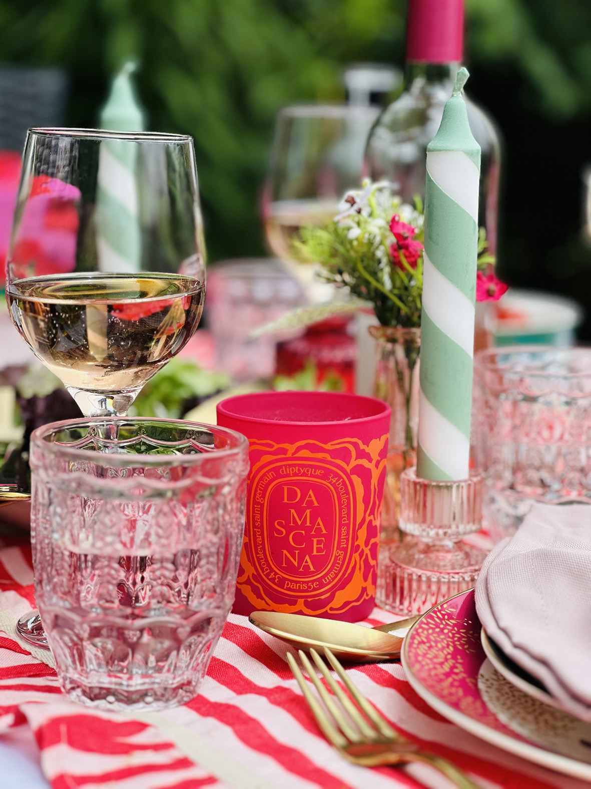 Diptyque candle on al fresco dining tablescape designed by Emma Green