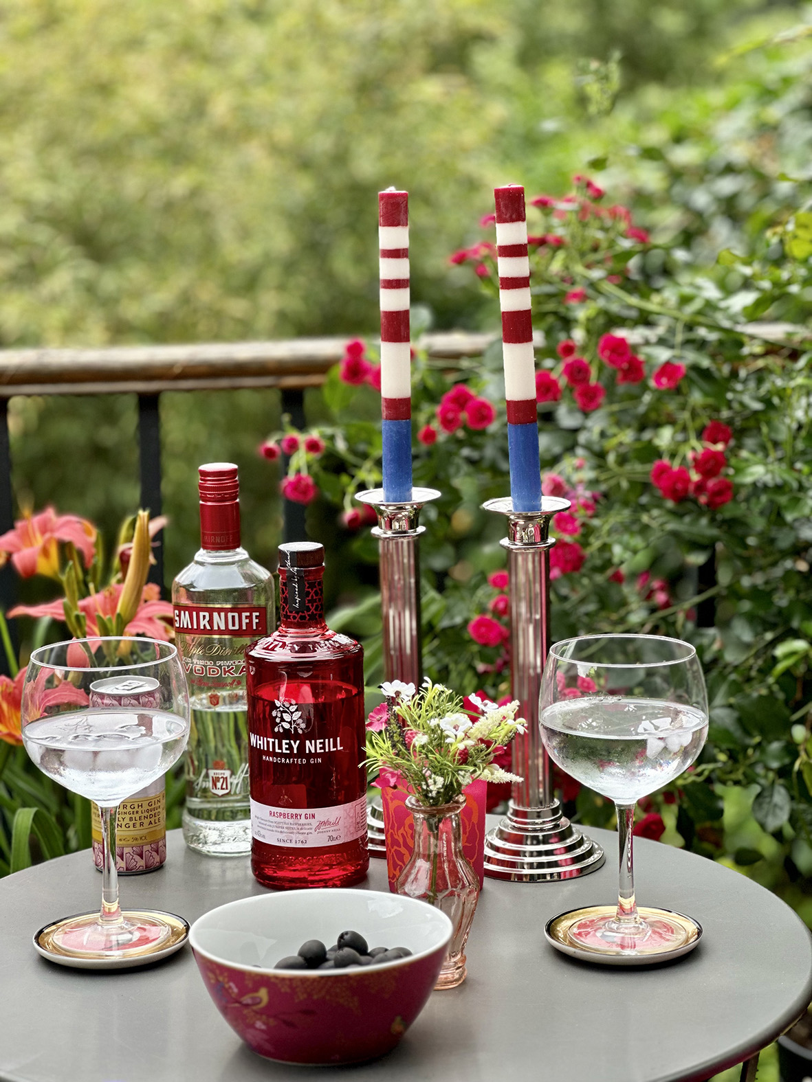 Striped candles on outdoor dining set designed by interior designer Emma Green