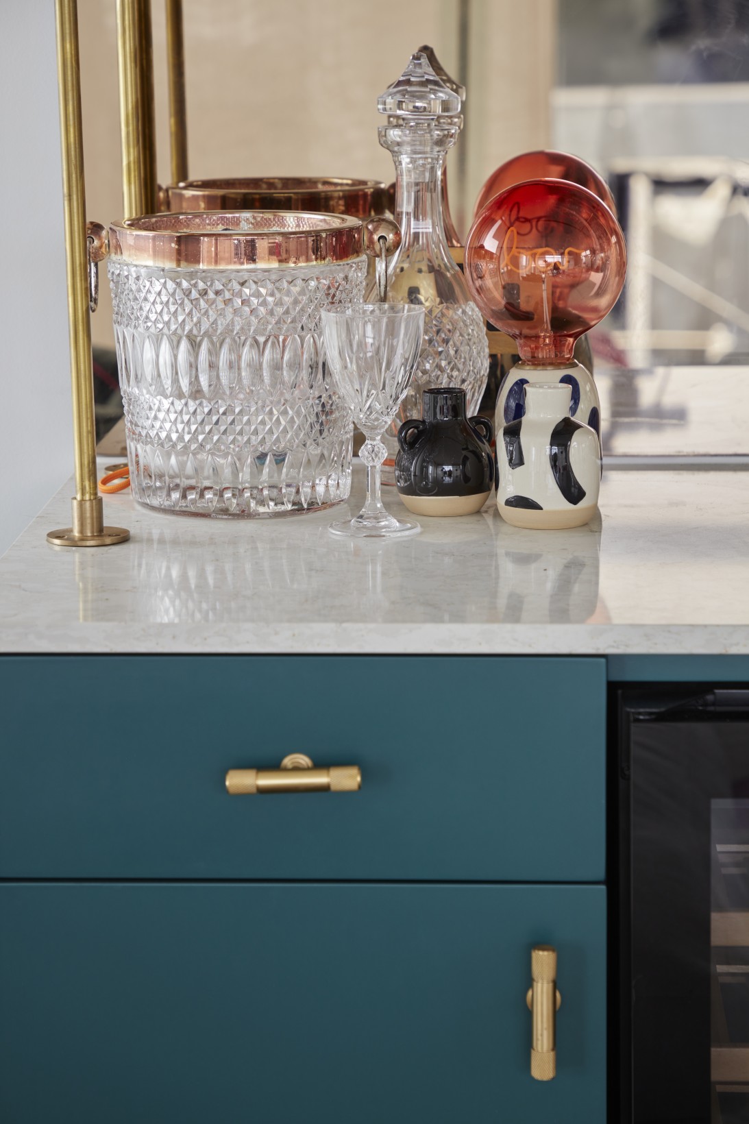 Crystalware, decanters, and bar styling on marble counter in penthouse party room