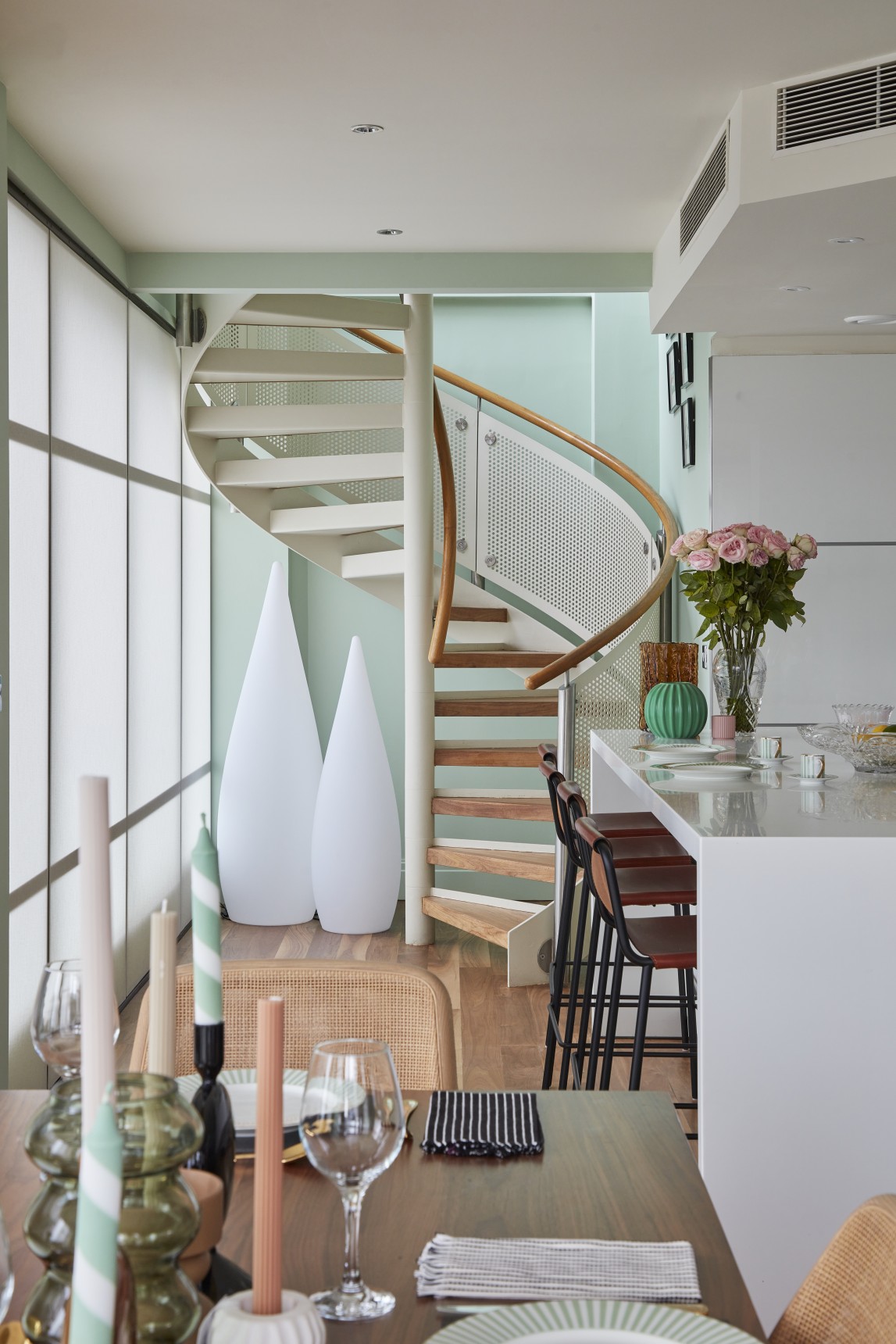 Spiral staircase and breakfast bar in riverside penthouse apartment, London