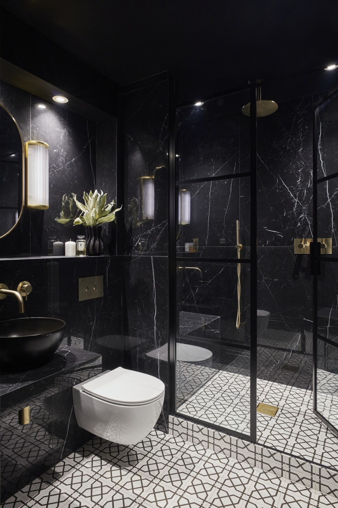 Penthouse bathroom with black marble, gold accents, and modern vanity basin