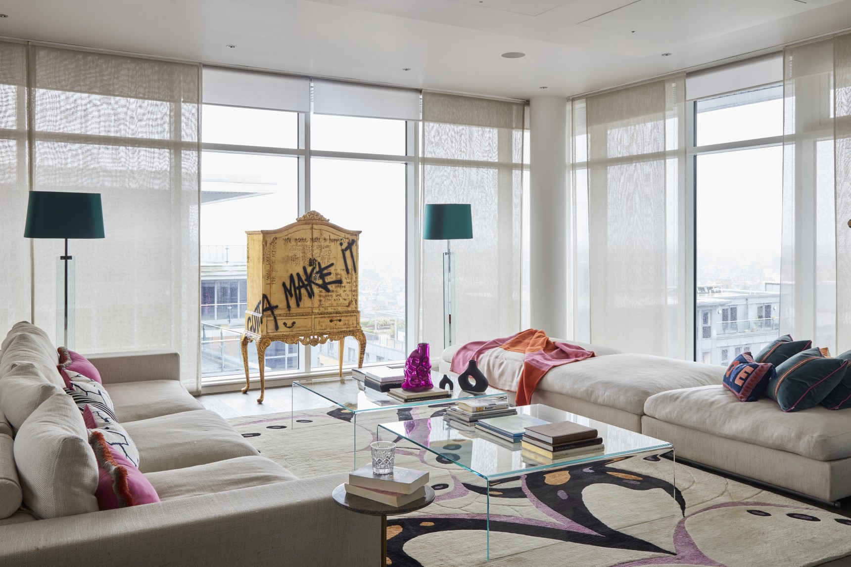 London penthouse party room with bespoke graffiti cabinet, glass tables, and expansive views
