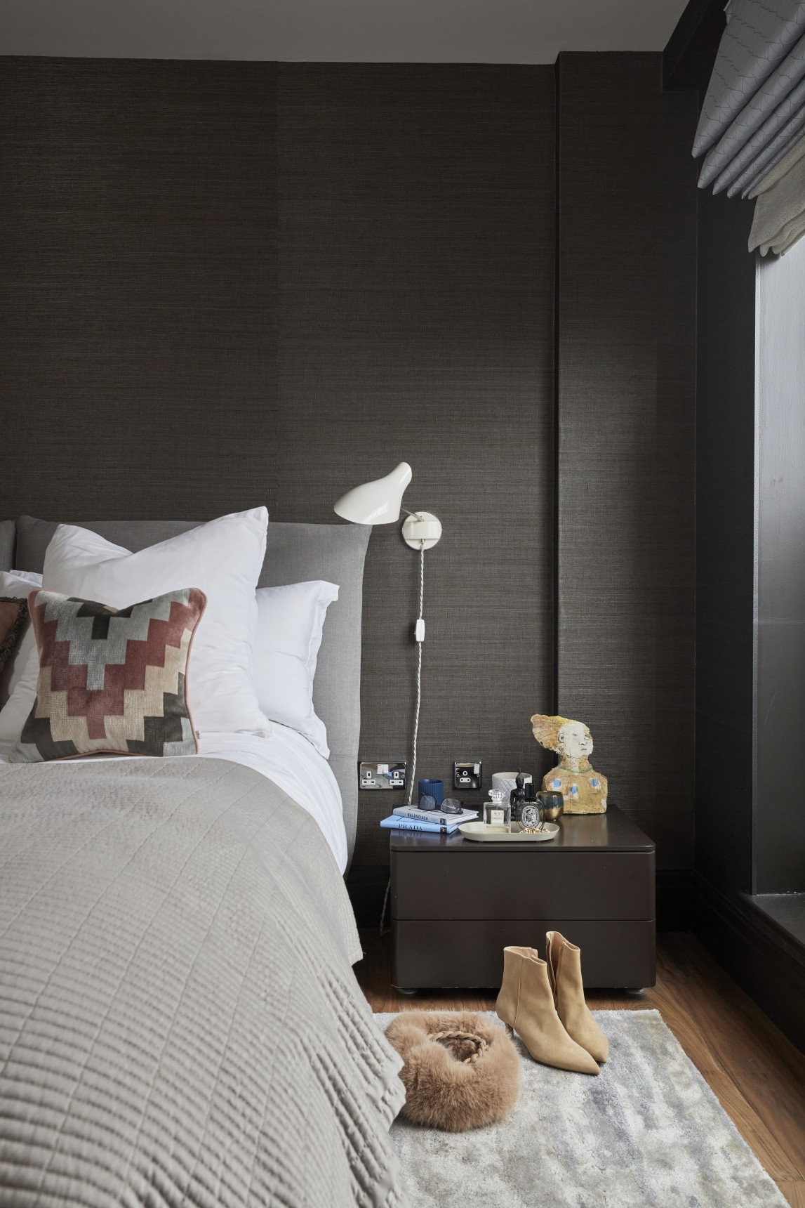 Master bedroom ideas featuring chocolate brown wallpaper, geometric accent cushions, and bespoke upholstered headboard.