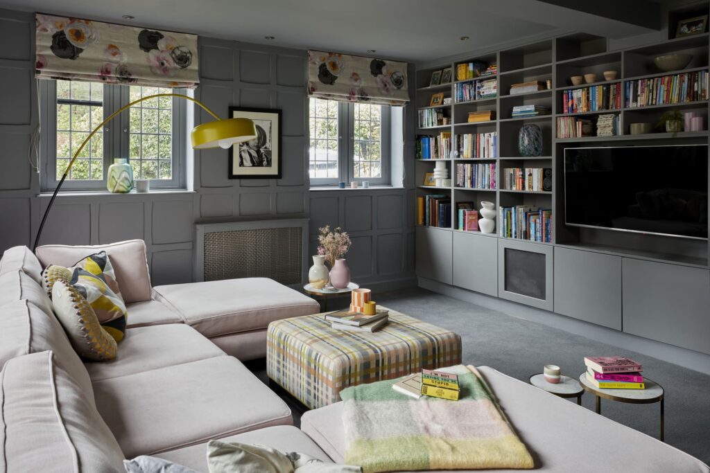 Bespoke library with integrated television and concealed technology in a London home designed by Emma Green Design.
