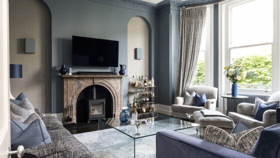 Formal living room interior in a Wandsworth home featuring a period fireplace, bespoke joinery, and blue-toned furnishings designed by Emma Green Design.