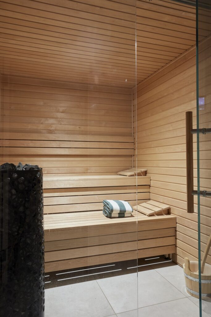 Residential sauna designed as part of a home wellness suite in Surrey by Emma Green Design.
