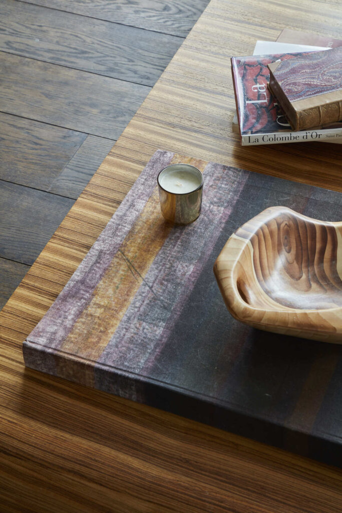 Timber coffee table with sculptural wooden accessories highlighting natural materials and craftsmanship in an Emma Green Design interior.