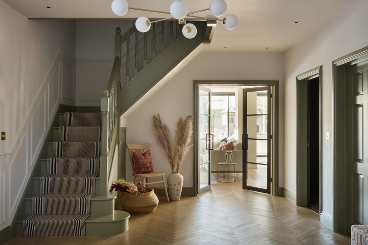 Green staircase hallway with panelling and natural textures