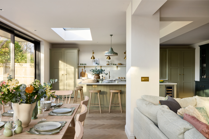 Open plan kitchen dining space with sage green cabinetry, Cotswolds project
